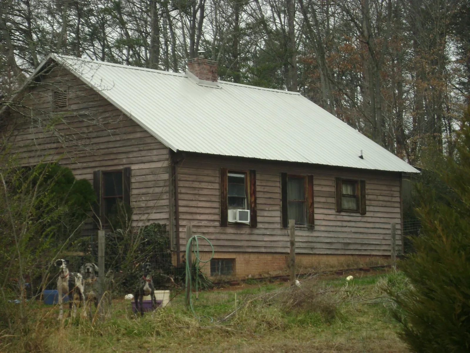 White metal roof on an old wood sided farmhouse, from a Metal Roof Installation job in Galion